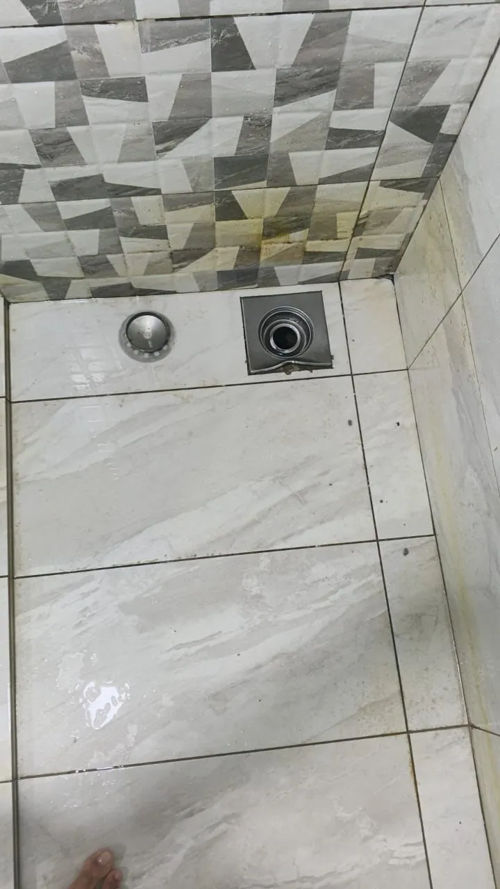 Bathroom floor drain installed between finished tiles