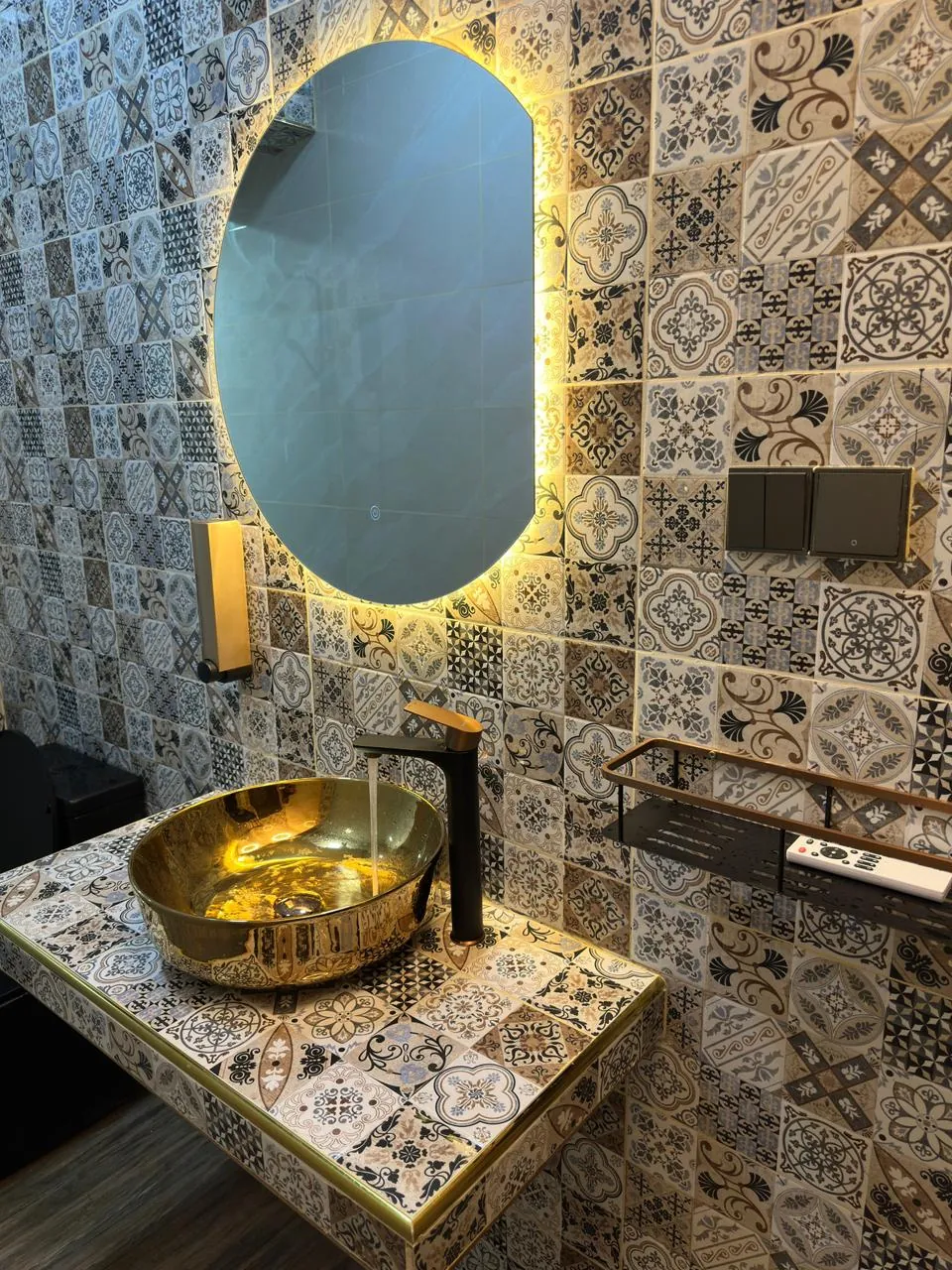 Finished patterned bathroom tiles around a modern vanity