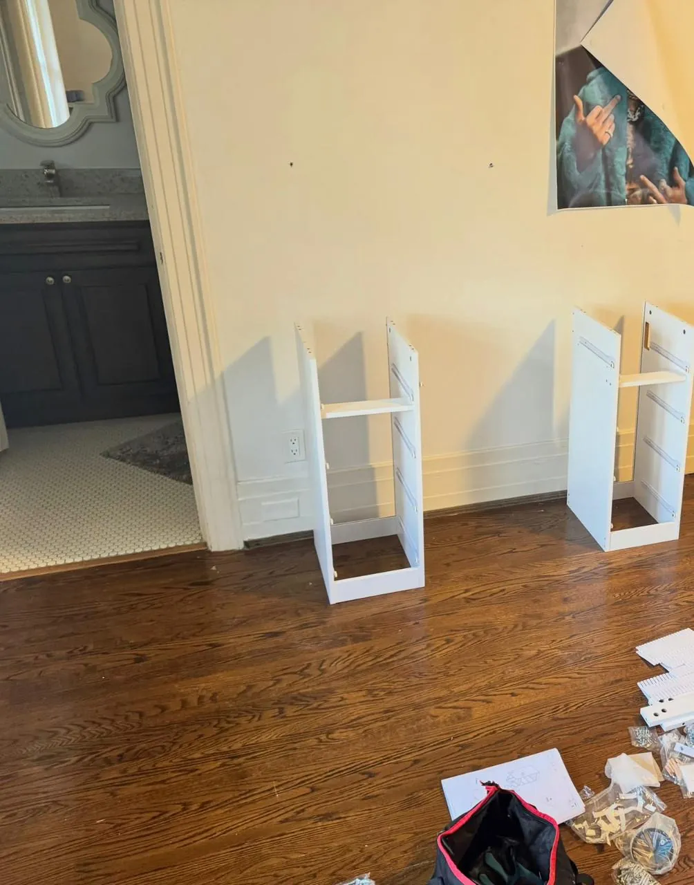 White shelving units assembled and positioned against a wall